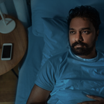 sleepless indian man lying in bed at home at night
