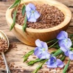 Alsi seeds on a table, spoon in a wooden bowl