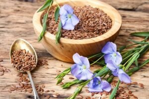 Alsi seeds on a table, spoon in a wooden bowl