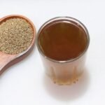 Ajwain seeds and a a glass of Ajwain water