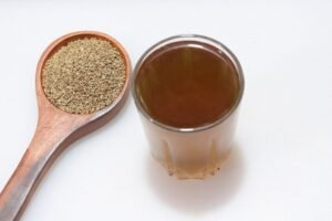 Ajwain seeds and a a glass of Ajwain water