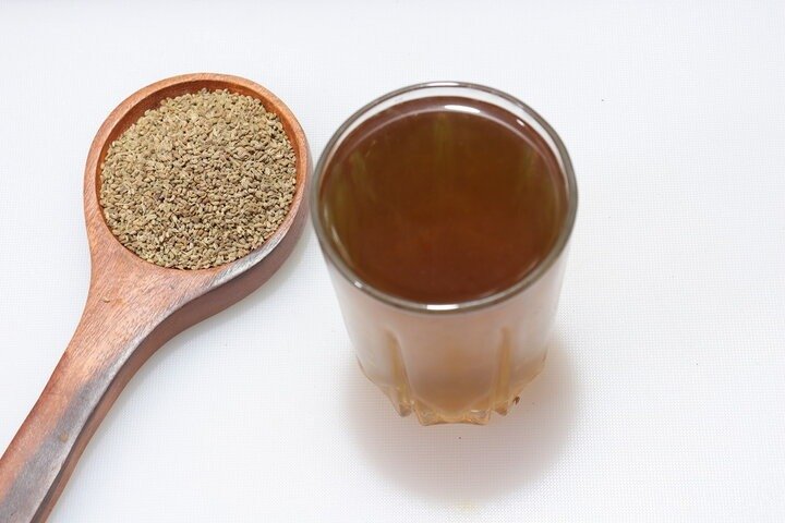 Ajwain seeds and a a glass of Ajwain water